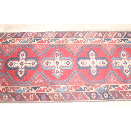 219 - A vintage red ground runner rug, possibly Turkish, approx 295cm x 78cm