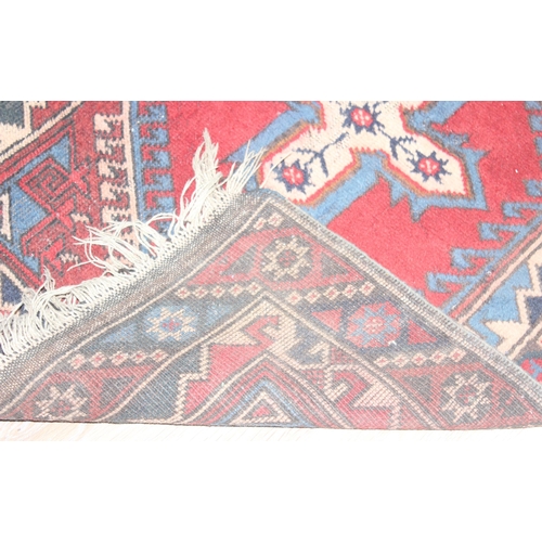 219 - A vintage red ground runner rug, possibly Turkish, approx 295cm x 78cm