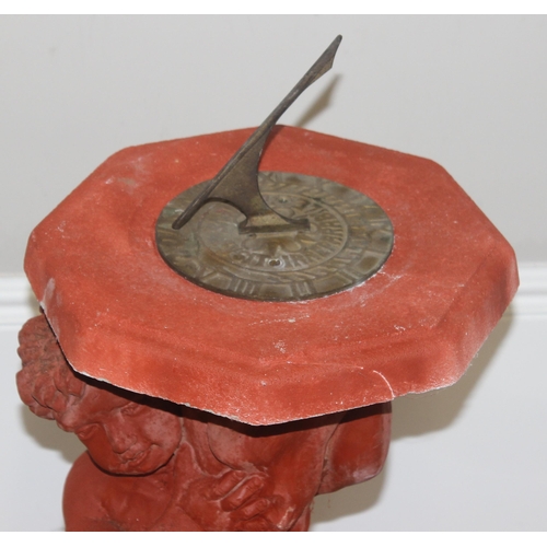 325 - The Stone Studio, garden sundial decorated as a young boy holding the top, approx 84cm H