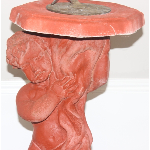 325 - The Stone Studio, garden sundial decorated as a young boy holding the top, approx 84cm H