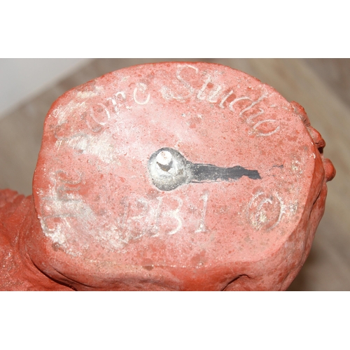 325 - The Stone Studio, garden sundial decorated as a young boy holding the top, approx 84cm H