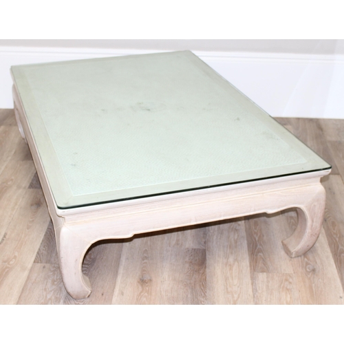 100 - An Oriental low tea table or coffee table, light or limed oak finish with woven top covered by glass... 