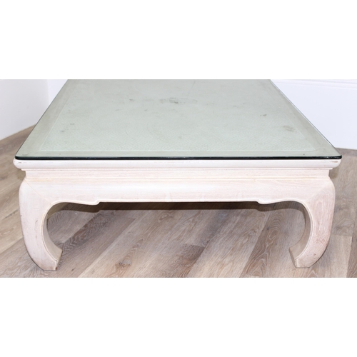 100 - An Oriental low tea table or coffee table, light or limed oak finish with woven top covered by glass... 