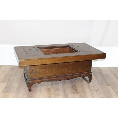 101 - A Japanese hardwood hibachi table with a central copper lined recess flanked by 2 smaller copper rec... 