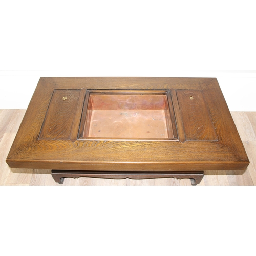 101 - A Japanese hardwood hibachi table with a central copper lined recess flanked by 2 smaller copper rec... 