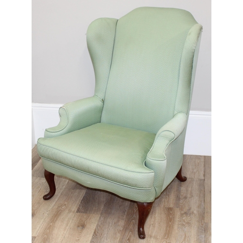 102 - 2 antique style wingback armchairs with wooden legs, one with celadon green coloured upholstery, the... 