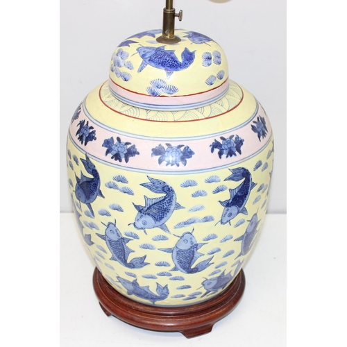 241 - An impressive pair of Chinese table lamps with shades, the body of each formed as a large pair of li... 