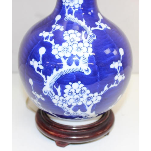 242 - A Chinese table lamp with shade, the body formed as a blue & white bottle vase decorated with prunus... 