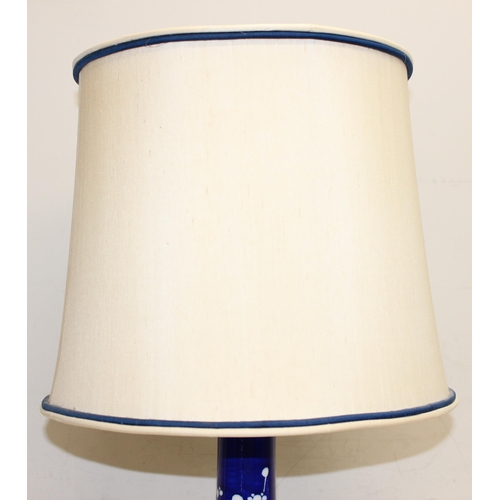 242 - A Chinese table lamp with shade, the body formed as a blue & white bottle vase decorated with prunus... 