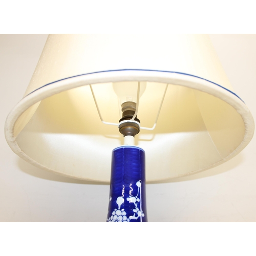 242 - A Chinese table lamp with shade, the body formed as a blue & white bottle vase decorated with prunus... 