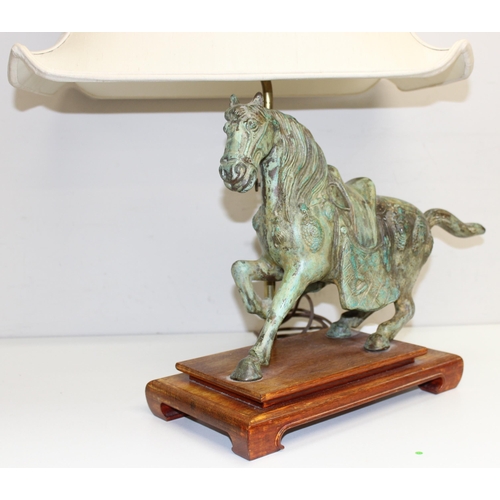 243 - A heavy patinated bronze table lamp formed as a Tang horse, with wooden base and with shade, approx ... 