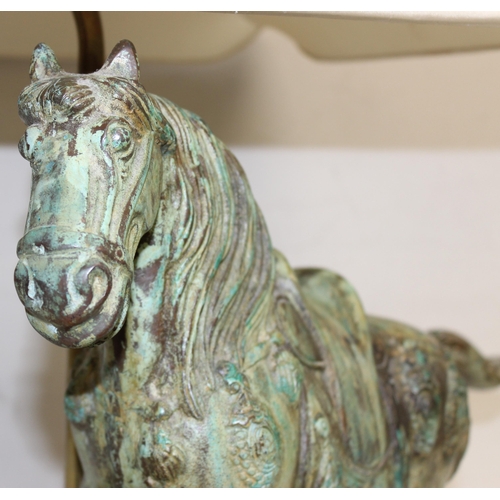 243 - A heavy patinated bronze table lamp formed as a Tang horse, with wooden base and with shade, approx ... 