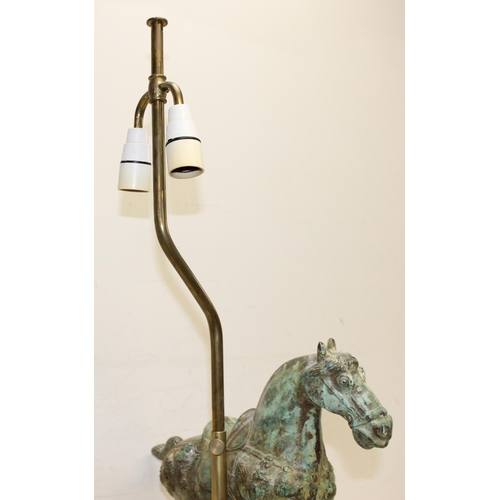 243 - A heavy patinated bronze table lamp formed as a Tang horse, with wooden base and with shade, approx ... 