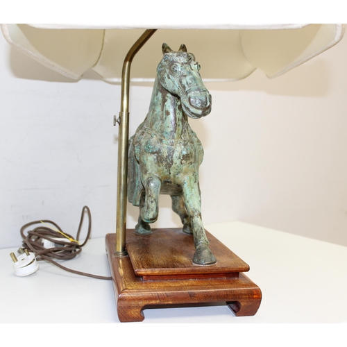 243 - A heavy patinated bronze table lamp formed as a Tang horse, with wooden base and with shade, approx ... 