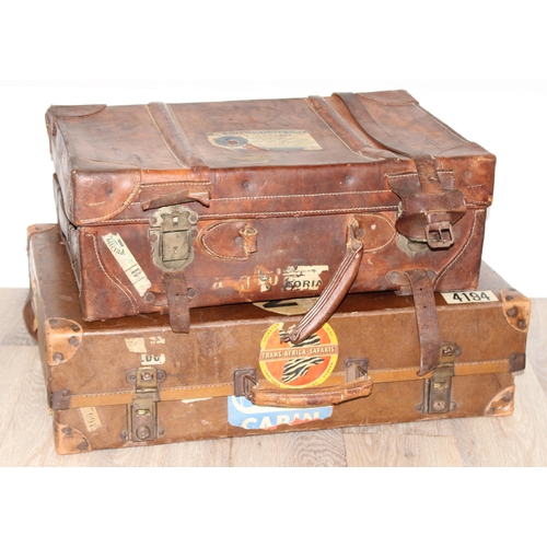 273 - 2 vintage suitcases with a large number of vintage luggage labels, the smaller case leather, the lar... 