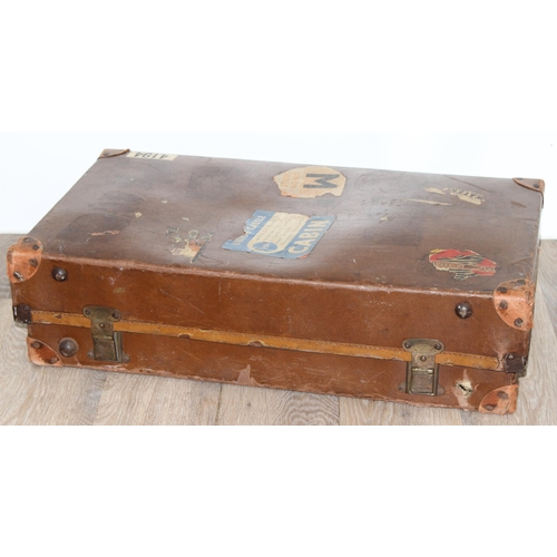 273 - 2 vintage suitcases with a large number of vintage luggage labels, the smaller case leather, the lar... 