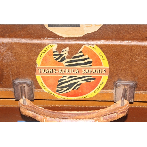 273 - 2 vintage suitcases with a large number of vintage luggage labels, the smaller case leather, the lar... 