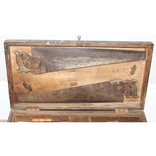 719 - A large vintage stained pine tool box with extensive contents to inc a number of wooden planes, saws... 