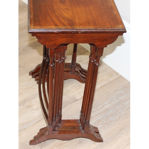 94 - An Edwardian style mahogany nest of 4 tables with turned legs, the largest approx 56cm wide x 35cm d... 