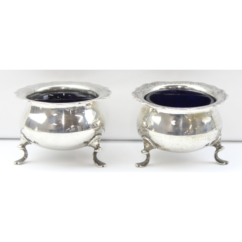 1054 - A pair of silver salts with blue glass liners, marked for Birmingham 1945 by Harrods, approx 74.74g ... 