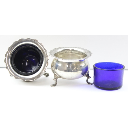 1054 - A pair of silver salts with blue glass liners, marked for Birmingham 1945 by Harrods, approx 74.74g ... 