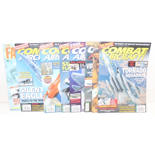 563 - Large qty of military related magazines and books to include Combat Aircraft magazine, Armed Forces ... 