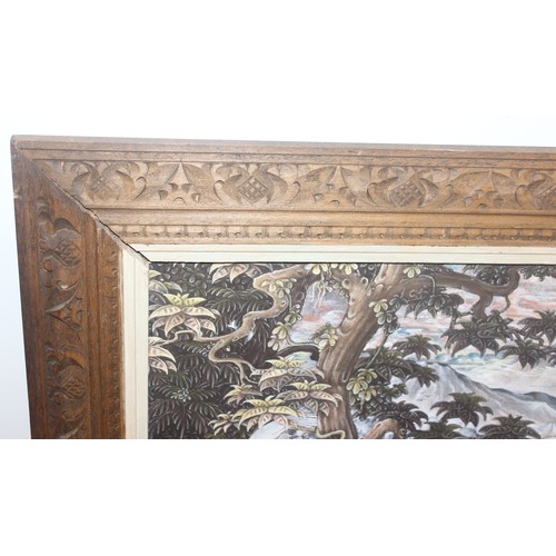 421 - Balinese School, painting on canvas of cranes within a forest setting, mounted in decorative carved ... 