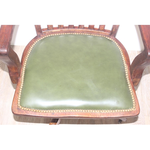 45 - A vintage slat back office chair with green leather seat, approx 92cm tall