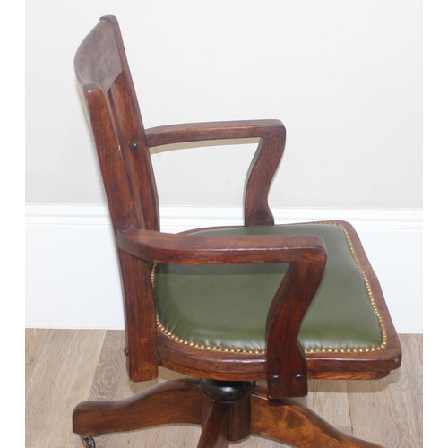 45 - A vintage slat back office chair with green leather seat, approx 92cm tall