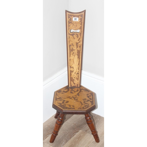 80 - An antique wooden spinning chair with pokerwork lion decoration, approx 87cm tall