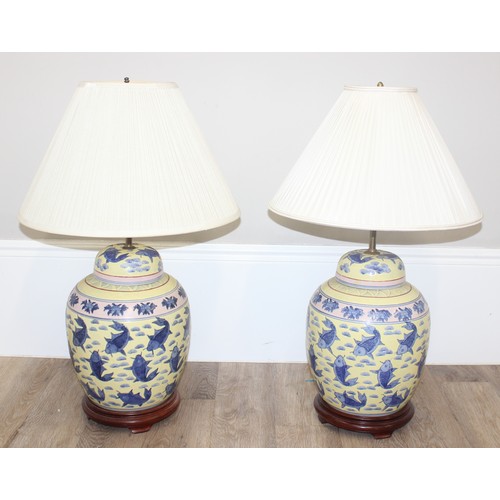 241 - An impressive pair of Chinese table lamps with shades, the body of each formed as a large pair of li... 