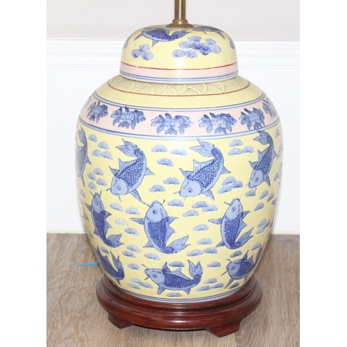 241 - An impressive pair of Chinese table lamps with shades, the body of each formed as a large pair of li... 