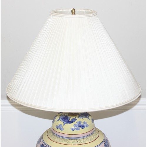 241 - An impressive pair of Chinese table lamps with shades, the body of each formed as a large pair of li... 