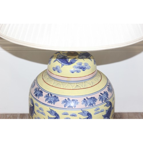 241 - An impressive pair of Chinese table lamps with shades, the body of each formed as a large pair of li... 