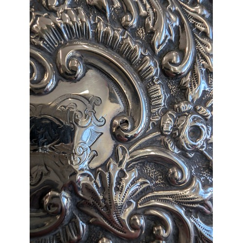 1050 - A highly decorative Chester silver cigar or cigarette box with embossed floral scrolls, marked for C... 