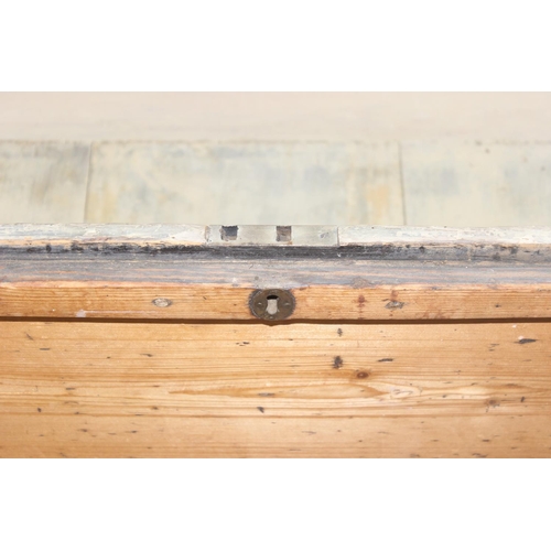 49 - Vintage pine wooden trunk on wheels with wrought iron handles and hinged lid, approx 77cm W x 44cm D... 