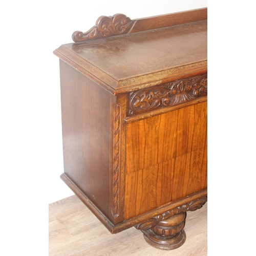 15 - A large 17th century style heavily carved oak sideboard with a central carved cupboard flanked by 2 ... 