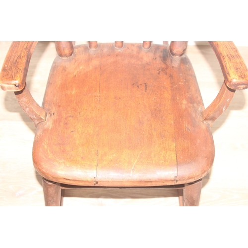 14 - An antique Swedish child's stick back rocking chair, bearing antique shipping label to base, likely ... 