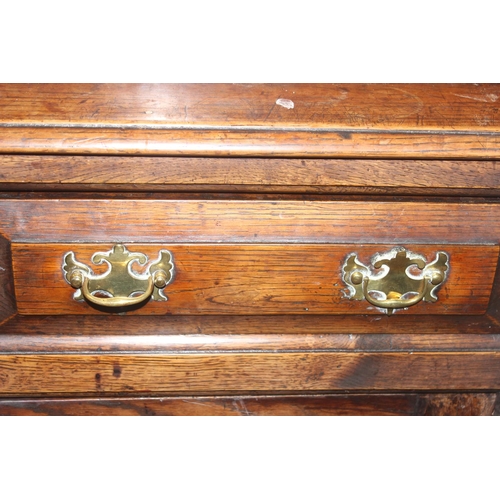 16 - An 18th century oak court cupboard with Georgian brass handles, dated 1754 and believed to be of tha... 