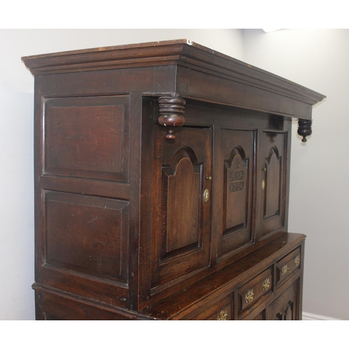 16 - An 18th century oak court cupboard with Georgian brass handles, dated 1754 and believed to be of tha... 