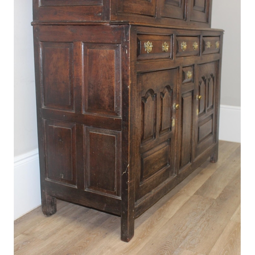 16 - An 18th century oak court cupboard with Georgian brass handles, dated 1754 and believed to be of tha... 