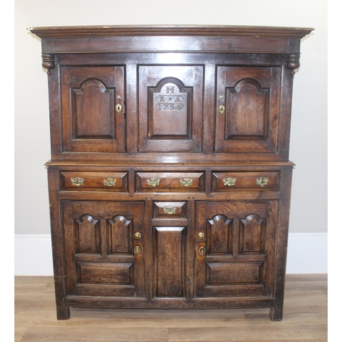 16 - An 18th century oak court cupboard with Georgian brass handles, dated 1754 and believed to be of tha... 