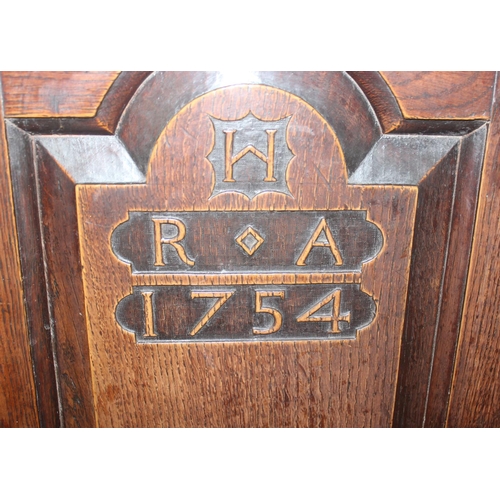 16 - An 18th century oak court cupboard with Georgian brass handles, dated 1754 and believed to be of tha... 