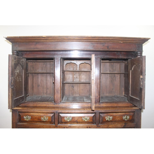 16 - An 18th century oak court cupboard with Georgian brass handles, dated 1754 and believed to be of tha... 