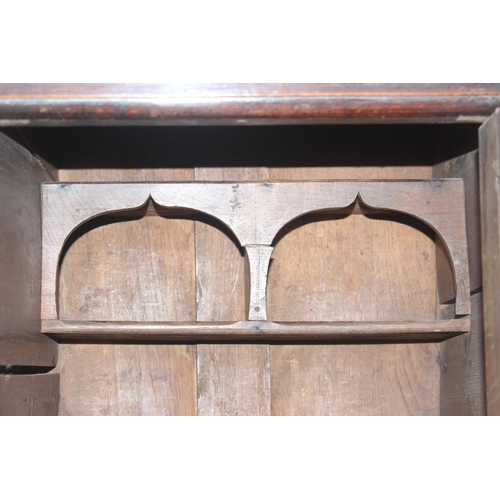 16 - An 18th century oak court cupboard with Georgian brass handles, dated 1754 and believed to be of tha... 