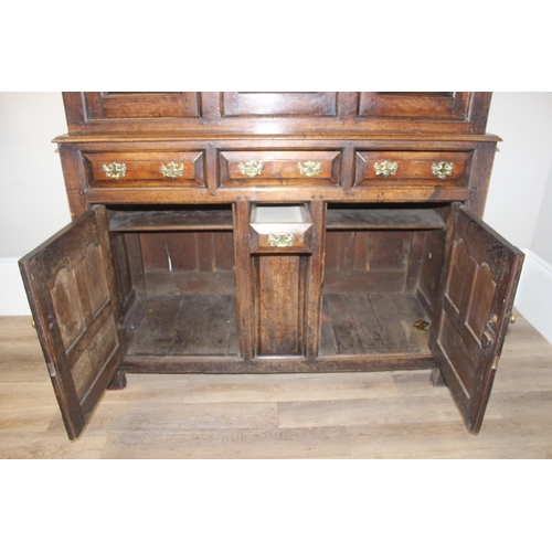 16 - An 18th century oak court cupboard with Georgian brass handles, dated 1754 and believed to be of tha... 