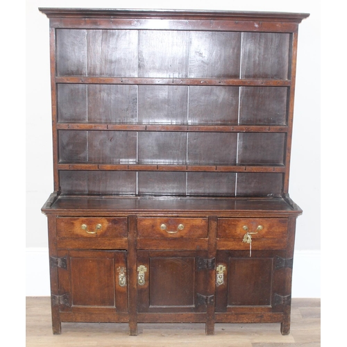 23 - An antique country oak dresser, likely 18th century, the base comprising of 3 cupboards under 3 draw... 