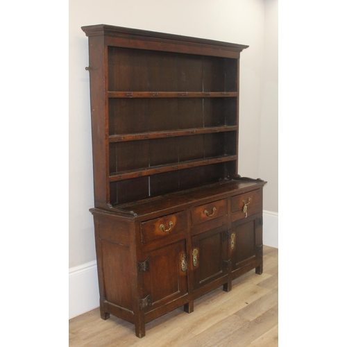 23 - An antique country oak dresser, likely 18th century, the base comprising of 3 cupboards under 3 draw... 