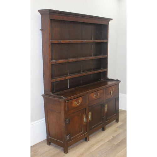 23 - An antique country oak dresser, likely 18th century, the base comprising of 3 cupboards under 3 draw... 