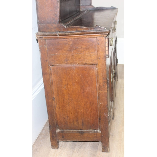 23 - An antique country oak dresser, likely 18th century, the base comprising of 3 cupboards under 3 draw... 